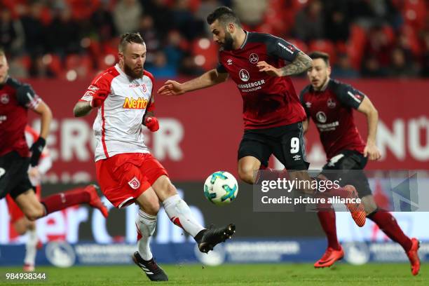 Nuremberg's Mikael Ishak and Jahn Regensburg's Marvin Knoll vying for the ball during the German 2nd division Bundesliga soccer match between 1. FC...