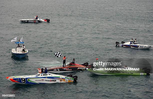 Rashed Khalifa al-Marri jubilates on top of his powerboat "Extreme Marine" after winning the 2010 UIM XCat Middle East Powerboat Championship in...