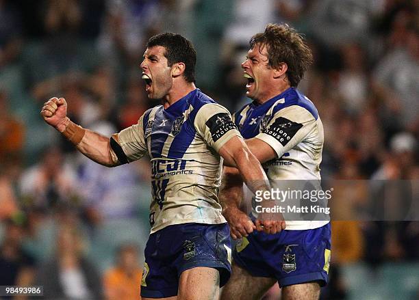 Brett Kimmorley of the Bulldogs celebrates with Michael Ennis after scoring the final try during the round six NRL match between the Wests Tigers and...