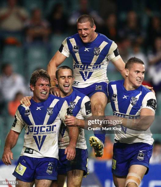 Brett Kimmorley of the Bulldogs celebrates with Steve Turner, Josh Morris and Tim Browne after scoring the final try during the round six NRL match...