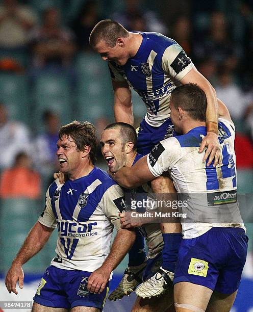 Brett Kimmorley of the Bulldogs celebrates with Steve Turner, Josh Morris and Tim Browne after scoring the final try during the round six NRL match...