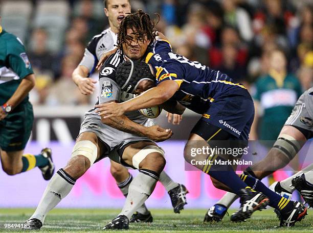 Rodney So'oialo of the Hurricanes is tackled during the round 10 Super 14 match between the Brumbies and the Hurricanes at Canberra Stadium on April...