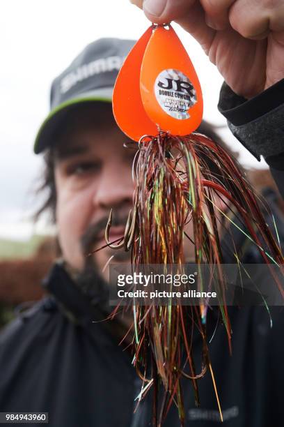 An angler shows a so-called Spinnerbait during the picture call before the fairs 'Jagd & Hund' and 'Fisch & Angel' in Dortmund, Germany, 24 January...