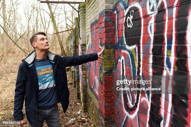 Local historian Christian Bormann stands next to an approximately 80-metre-long piece of the Berlin Wall in Pankwo in Berlin, Germany, 24 January...
