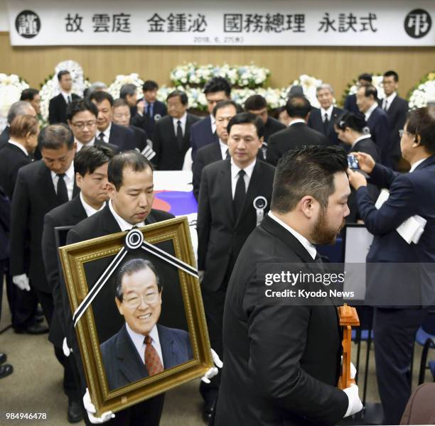 Photo of former South Korean Prime Minister Kim Jong Pil is carried at his funeral in Seoul on June 27, 2018. Kim, who played a pivotal role in...