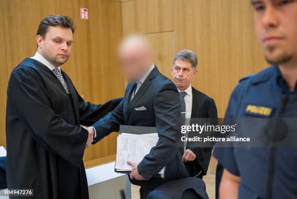June 2018, Germany, Munich: The defendant Robert P. Is greeted by his lawyers Benjamin Ruhlmann and Hans Schroeder at the begin of the trial...
