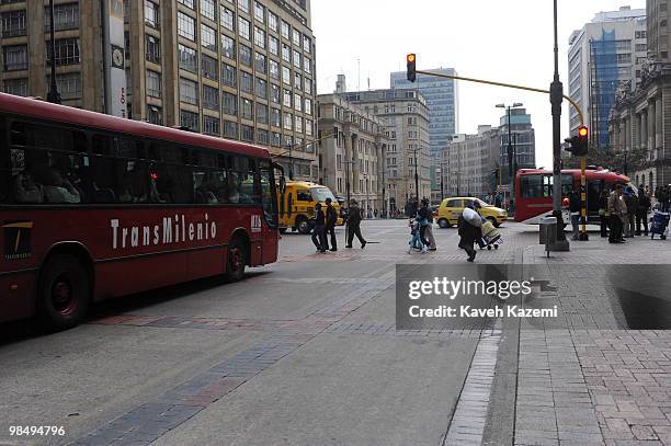 Street with Transmilenio bus running. In both direction. TransMilenio is a bus rapid transit system that serves Bogota, Colombia. The system runs...