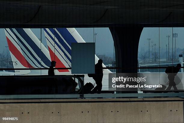 Passengers walk in a terminal at the Charles-de-Gaulle airport in Roissy on April 16, 2010 in Paris, France. Roissy Charles-de-Gaulle airport has...