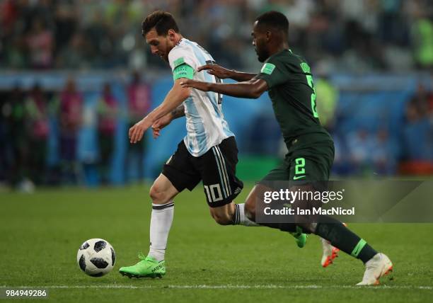 Lionel Messi of Argentina vies with Brian Idowu of Nigeria during the 2018 FIFA World Cup Russia group D match between Nigeria and Argentina at Saint...