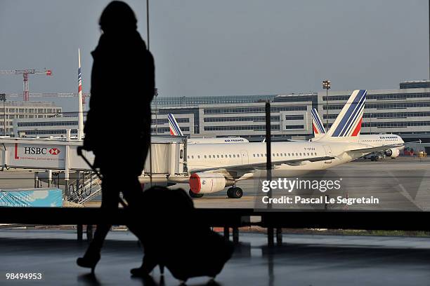 Passenger walks in a terminal at the Charles-de-Gaulle airport in Roissy on April 16, 2010 in Paris, France. Roissy Charles-de-Gaulle airport has...