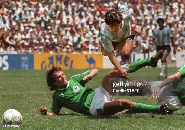 Argentina's soccer star team captain Diego Maradona evades a tackle from West Germany's Lothar Matthaus during the World Soccer Cup final, won by...