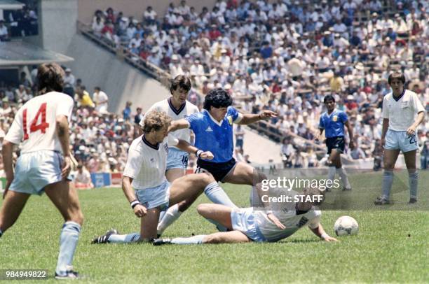 Argentinian midfielder Diego Maradona dribbles past three English defenders on June 22, 1986 in Mexico City during the World Cup quarterfinal soccer...