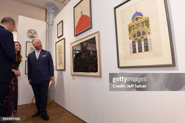 Prince Charles, Prince of Wales looks at art as he attends The Prince's Foundation School of Traditional Arts degree show in Shoreditch on June 27,...