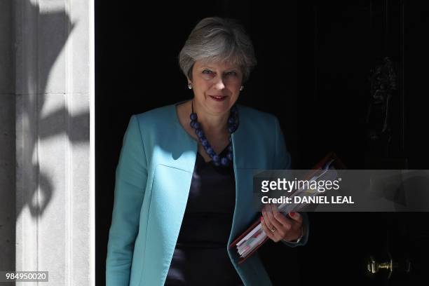 Britain's Prime Minister Theresa May leaves 10 Downing Street in central London on June 27 as she heads to the weekly Prime Minister's Questions...