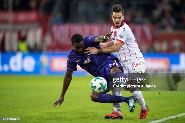 Duesseldorf's Niko Giesselmann and Aue's Ridge Munsy vying for the ball during the German Second Bundesliga soccer match between Fortuna Duesseldorf...
