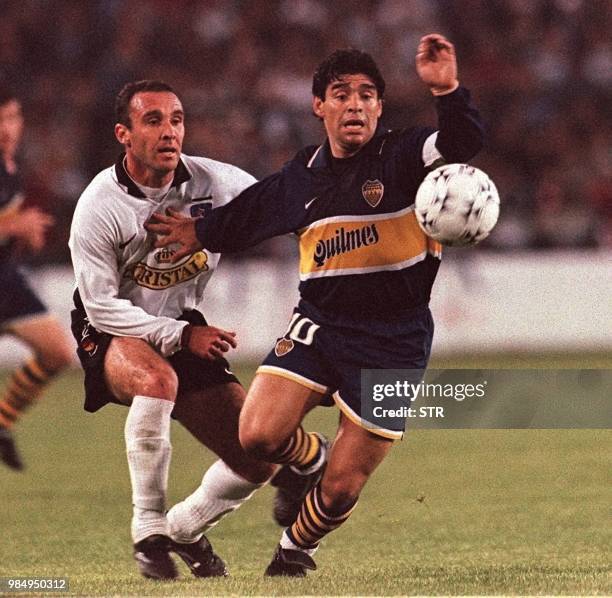 Argenitna's Boca Juniors Diego Armando Maradona and Marcelo Espina of Chile's Colo Colo battle for the ball during their Group One South American...