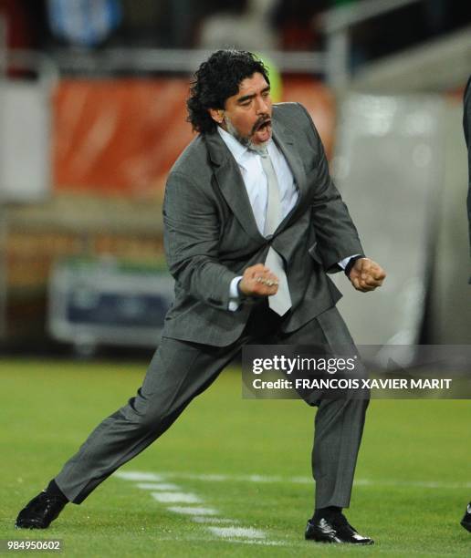 Argentina's coach Diego Maradona celebrates after Argentina's defender Martin Demichelis scored during the Group B first round 2010 World Cup...