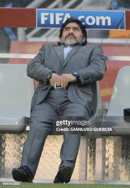 Argentina's coach Diego Maradona adjusts his trousers during their Group B first round 2010 World Cup football match on June 17, 2010 at Soccer City...