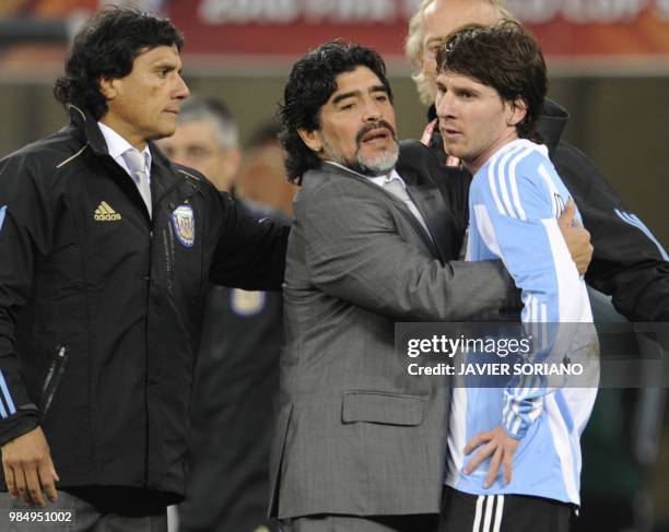 Argentina's coach Diego Maradona hugs Argentina's striker Lionel Messi after the 2010 World Cup quarter final Argentina vs Germany on July 3, 2010 at...