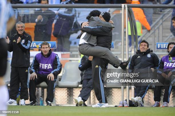 Argentina's coach Diego Maradona celebrates with staff member during the Group B first round 2010 World Cup football match Argentina versus South...