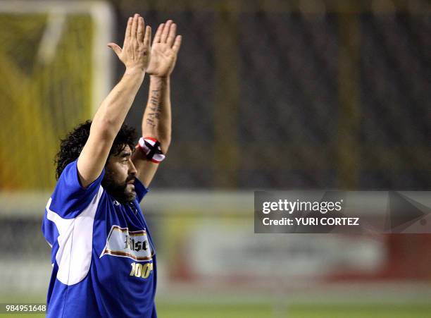 Argentinian Diego Armando Maradona applauds during a football match at the Cuscatlan stadium against a combined team of El Salvador in San Salvador,...