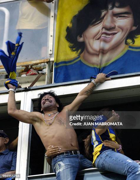 Former soccer star Diego Maradona celebrates, next to his daughter Dalma, after Boca Juniors' Martin Palermo scored against River Plate 26 March,...