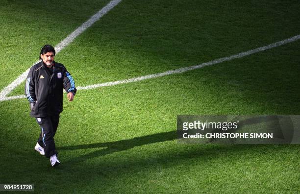 Argentina's coach Diego Maradona walks on the pitch as the teams warm up before the 2010 World Cup quarter-final football match between Argentina and...