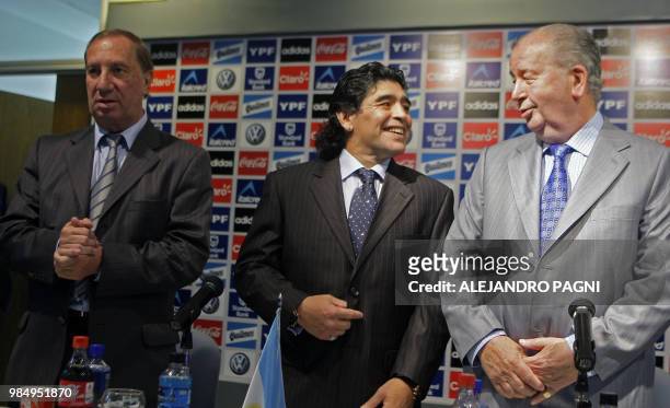 Argentinian football legend Diego Maradona and 1986 World Cup winning coach Carlos Bilardo stand next to the president of the Argentinian Football...