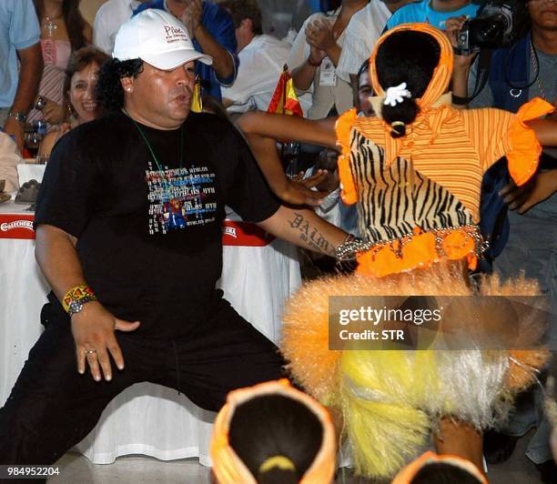 Argentina's soccer star Diego Maradona dances 31 January 2004 in Barranquilla during a farewell party in honor of Colombian Carlos Valderrama's...