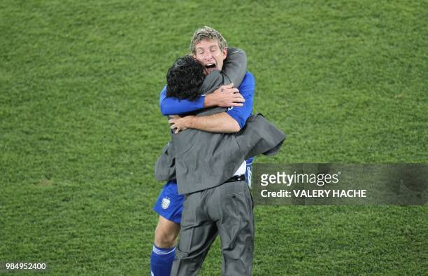 Argentina's striker Martin Palermo celebrates with Argentina's coach Diego Maradona after he scored during the Group B first round 2010 World Cup...