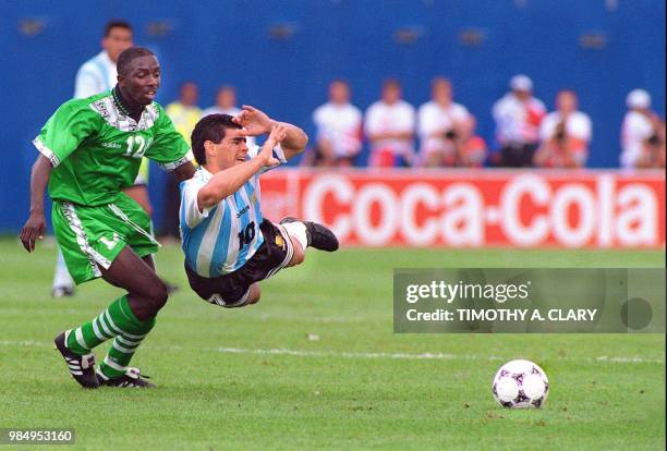 Argentinian midfielder Diego Maradona grimaces as he falls after being fouled by Nigerian Samson Siasia 26 June 1994 at Foxboro stadium in Boston...