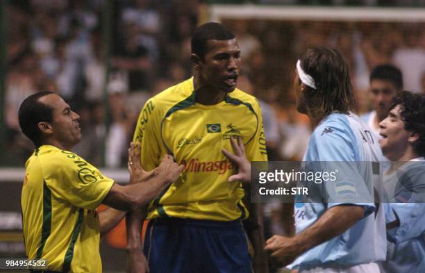 Ailton and Junior Bahiano of Brazil argue with Gabriel Amato and Diego Maradona of Argentina during their friendly "Showbol" match at the Luna Park...