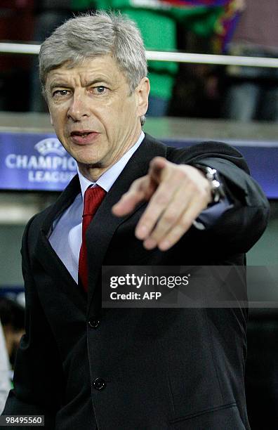 Arsenal's French coach Arsene Wenger gestures during their UEFA Champions League quarter-final 2nd leg football match against Arsenal at the Camp Nou...