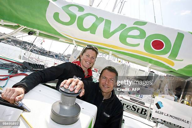 British offshore sailor Samantha Davies and her companion French yachtman Romain Attanasio pose on their monohull "Saveol", on April 16, 2010 in...