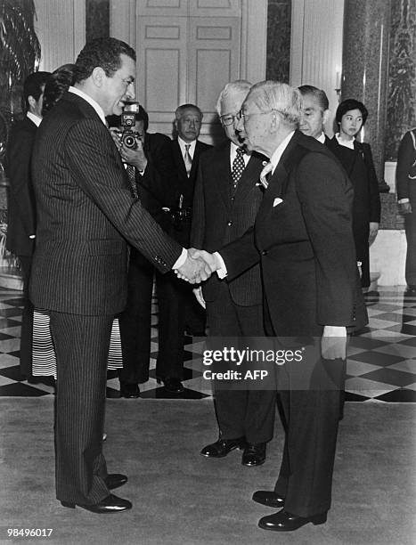 Egyptian President Hosni Mubarak shakes hands with Japanese Emperor Hirohito on April 06, 1983 in Tokyo during his official visit to Japan. AFP /...