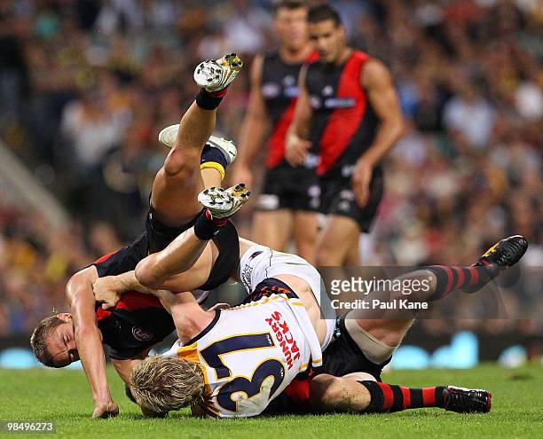 Adam Selwood of the Eagles wrestles with Scott Gumbleton and Heath Hocking of the Bombers during the round four AFL match between the West Coast...