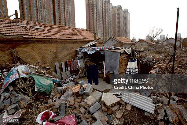 Clothes hang out to dry outside a house in a shanty town near new construction on April 15, 2010 in Changchun, Jilin Province, China. Many low-income...