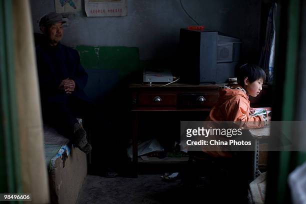 Residents are seen in their house in a shanty town near new construction on April 15, 2010 in Changchun, Jilin Province, China. Many low-income...