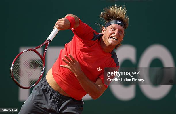 David Nalbandian of Argentina serves to Novak Djokovic of Serbia during day five of the ATP Masters Series at the Monte Carlo Country Club on April...