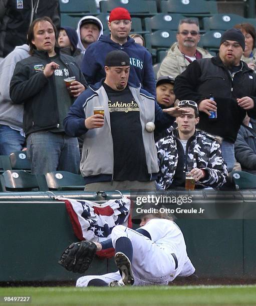 Left fielder Eric Byrnes of the Seattle Mariners makes a sliding attempt to catch a foul ball against the Oakland Athletics at Safeco Field on April...