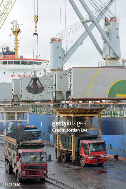 unloading coal from the tanker - jordan lye stock pictures, royalty-free photos & images