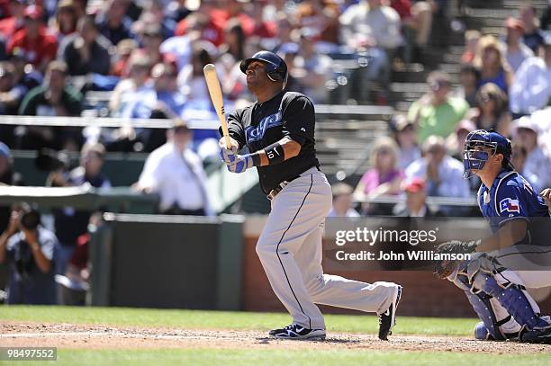 Vernon Wells of the Toronto Blue Jays hits a home run and watches the ball as he runs to first base from the batter's box during the game against the...