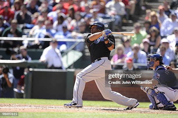 Vernon Wells of the Toronto Blue Jays bats and hits a home run during the game against the Texas Rangers at Rangers Ballpark in Arlington in...