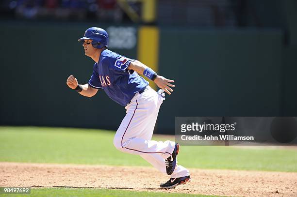 Michael Young of the Texas Rangers runs from first base as the batter puts the ball in play during the game against the Toronto Blue Jays at Rangers...