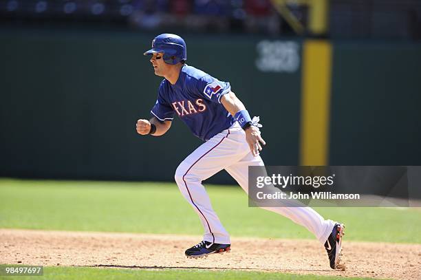 Michael Young of the Texas Rangers runs from first base as the batter puts the ball in play during the game against the Toronto Blue Jays at Rangers...