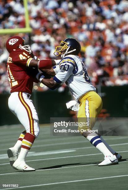 S: Tight End Kellen Winslow of the San Diego Chargers tangles up with defensive back Herb Christopher of the Kansas City Chiefs circa early 1980's...