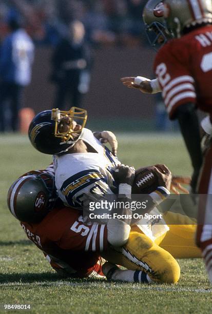 Tight End Kellen Winslow of the San Diego Chargers is tackled by linebacker Willie Harper of the San Francisco 49ers circa 1979 during an NFL...