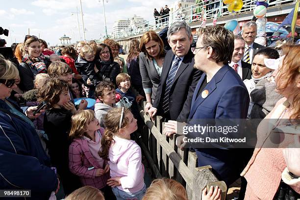 British Prime Minister Gordon Brown, wife Sarah Brown, and Eddie Izzard talk with youngsters as they take a stroll down Brighton sea front on April...