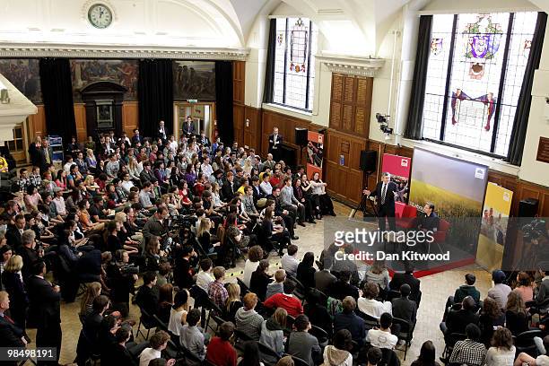 British Prime Minister Gordon Brown stands beside Eddie Izzard as speaks to students at Brighton and Hove sixth form college on April 16, 2010 in...