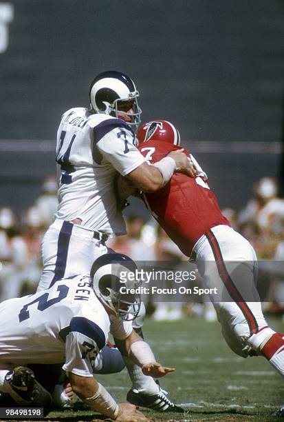 S: Defensive Tackle Merlin Olsen of the Los Angeles Rams is blocked by guard Jeff Van Note of the Atlanta Falcons circa early 1970's during an NFL...